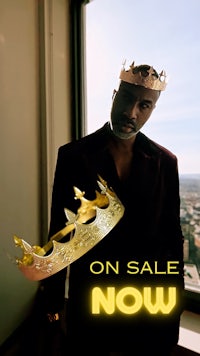 a man in a suit with a crown on sale now